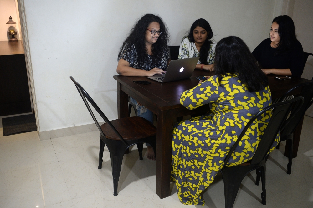 In this photograph taken on October 26, 2019, Vandita Morarka, 25, interacts with her colleagues as they sit around rented furnitures in Mumbai. AFP / PUNIT PARANJPE 
