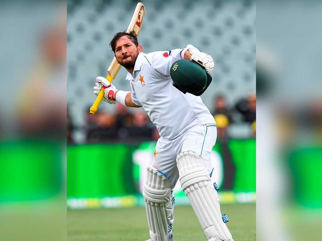 Pakistan batsman Yasir Shah celebrates scoring his century against Australia on the third day of the second cricket Test match in Adelaide on December 1, 2019. AFP / William West 