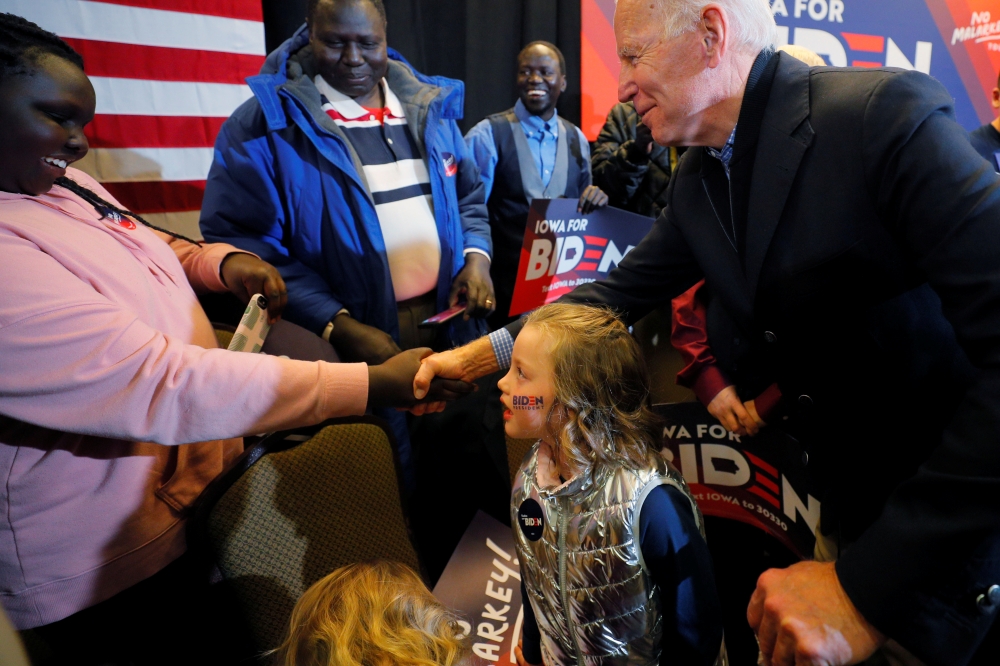 Joe Biden greets audience members during a stop on his 