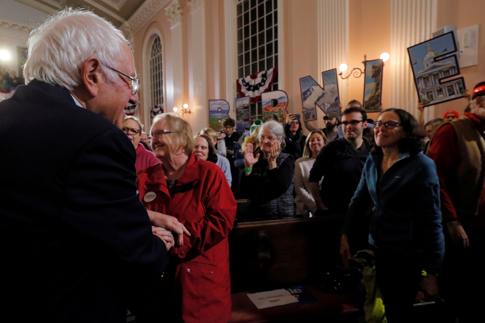 Bernie Sanders greets audience members at a campaign town hall meeting in Portsmouth, New Hampshire, US, November 24, 2019. Reuters/Brian Snyder