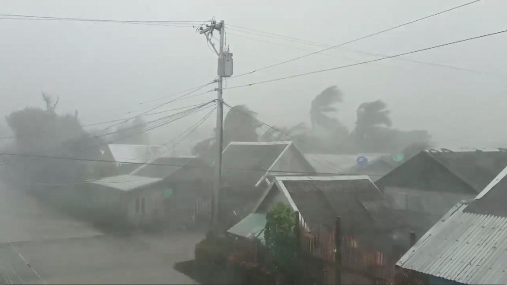 Trees sway near buildings as Typhoon Kammuri, known locally as Typhoon Tisoy, makes landfall in Gamay, Northern Samar, Philippines, December 2, 2019, in this still image from video obtained via social media. Gladys Castillo Vidal via REUTERS ATTENTION EDI