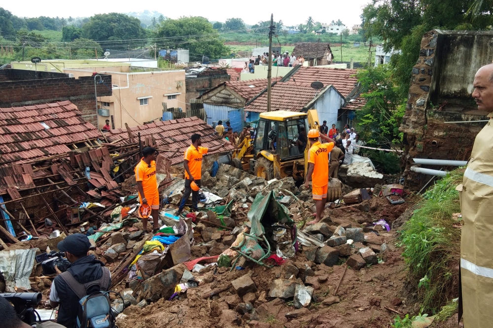 Rescue workers clear debris from a collapsed home in Mettupalayam, some 50 kilometres (30 miles) north of Coimbatore, on December 2, 2019. At least 17 people from four families in India were buried alive as they were sleeping on December 2 when heavy rain