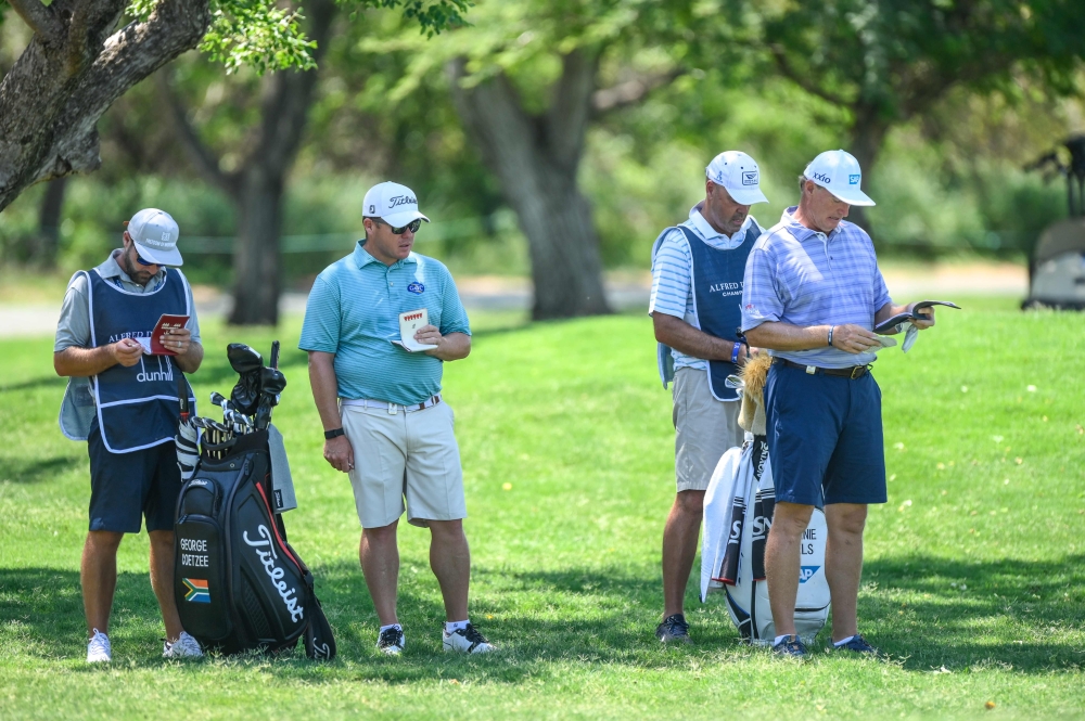 South Africa's George Coetzee (2ndL) and South Africa's Ernie Els (R) playing in shortsduring the first day of the Dunhill Championship golf tournament at Leopard Creek in Malelane, on November 28, 2019. / AFP / CHRISTIAAN KOTZE
