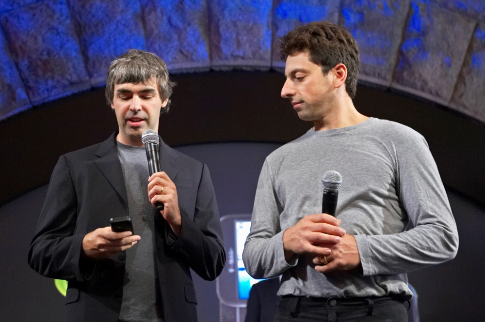FILE PHOTO: Larry Page (L) and Sergey Brin, co-founders of Google, show the new G1 phone running Google's Android software in New York September 23, 2008. REUTERS/Jacob Silberberg/File Photo
 