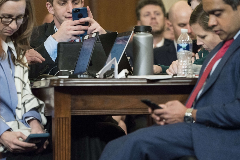 Journalists use their phones as constitutional scholars testify before the House Judiciary Committee in the Longworth House Office Building on Capitol Hill December 4, 2019 in Washington, DC. Sarah Silbiger/Getty Images/AFP