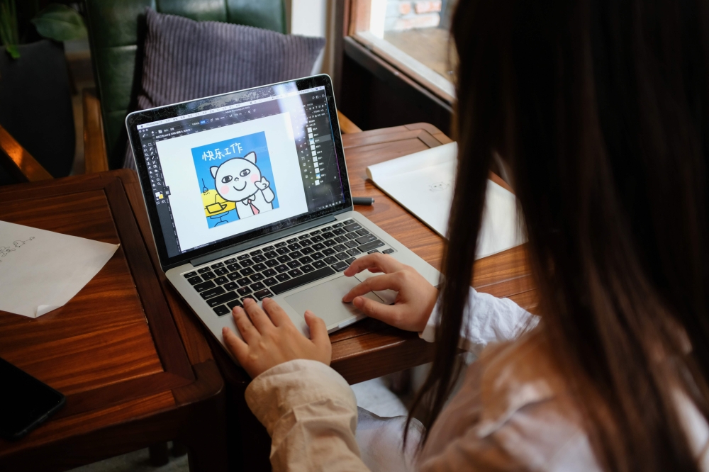 This photo taken on July 3, 2019 shows Chinese artist River Rui looking at an image of her 