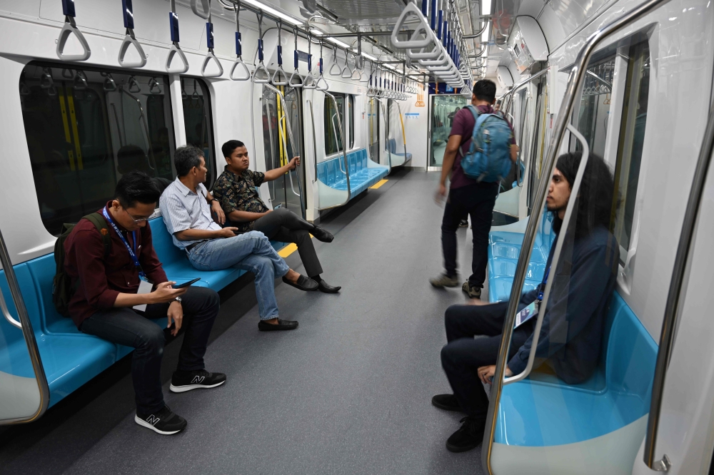 This picture taken on March 12, 2019 shows passengers on board a Jakarta mass rapid transit MRT coach during a trial run in the city. AFP / Bay Ismoyo