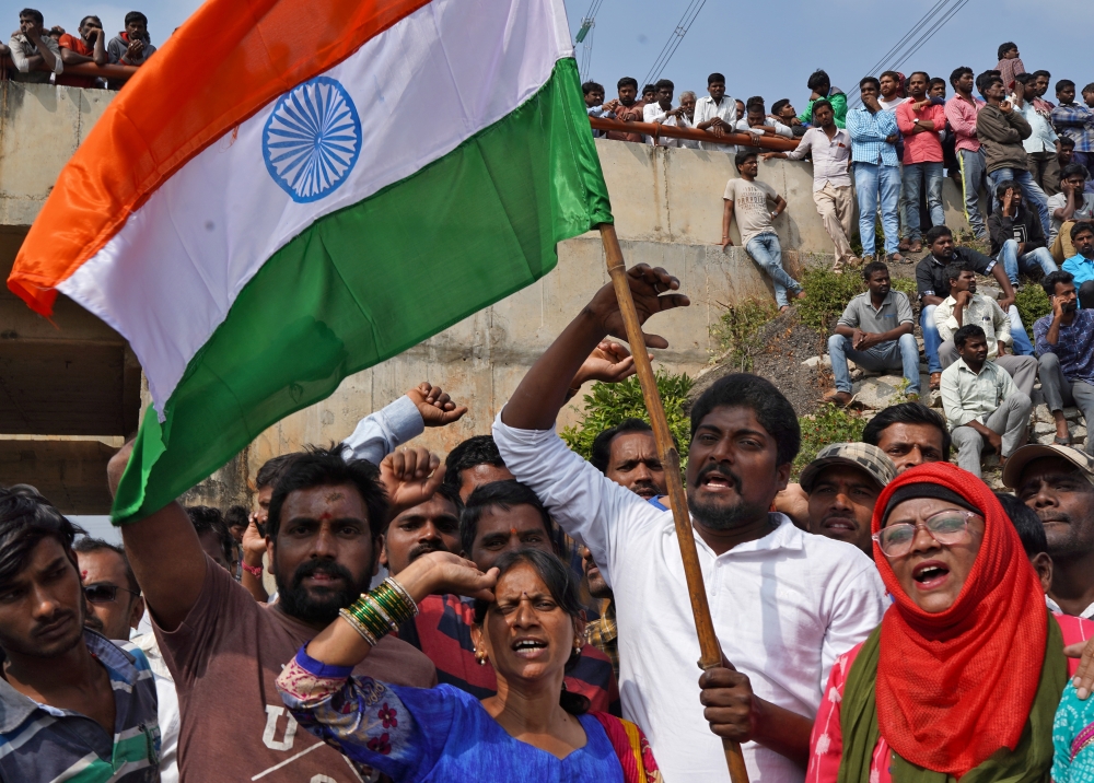 People shout slogans as they gather at the site where police shot dead four men suspected of raping and killing a 27-year-old veterinarian, in Chatanpally on the outskirts of Shadnagar town, Telangana, India, December 6, 2019. REUTERS/Swarat Ghosh
 