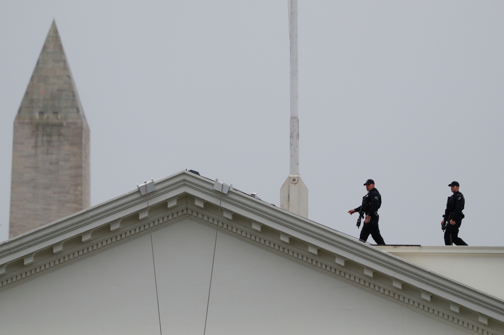 Uniformed US Secret Service Agents stand along the rooftop of the White House in Washington, US, December 2, 2019. Reuters/Tom Brenner