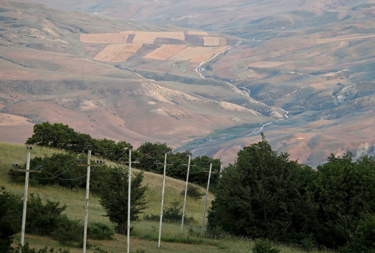 Electricity pylons of a high-tension electricity power line are seen outside the village of Qalaalti, Azerbaijan, June 20, 2016. Reuters/Maxim Shemetov 
