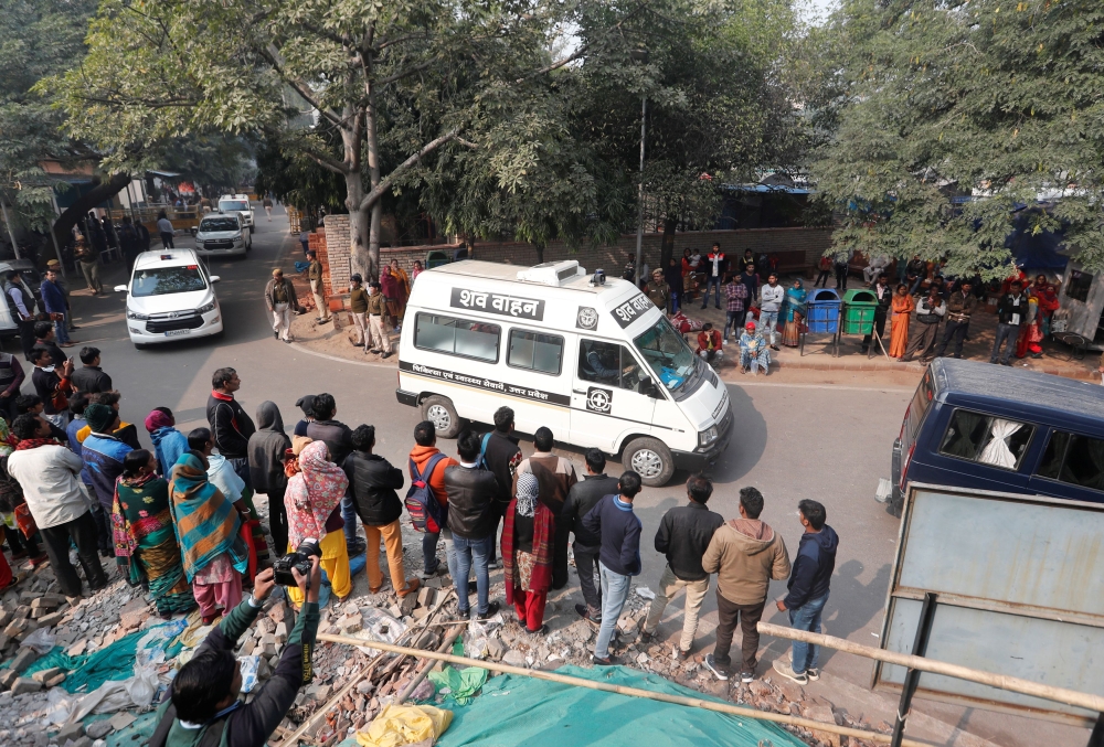 A hospital vehicle carries the body of a rape victim to her residence in New Delhi, India, December 7, 2019. REUTERS/Adnan Abidi