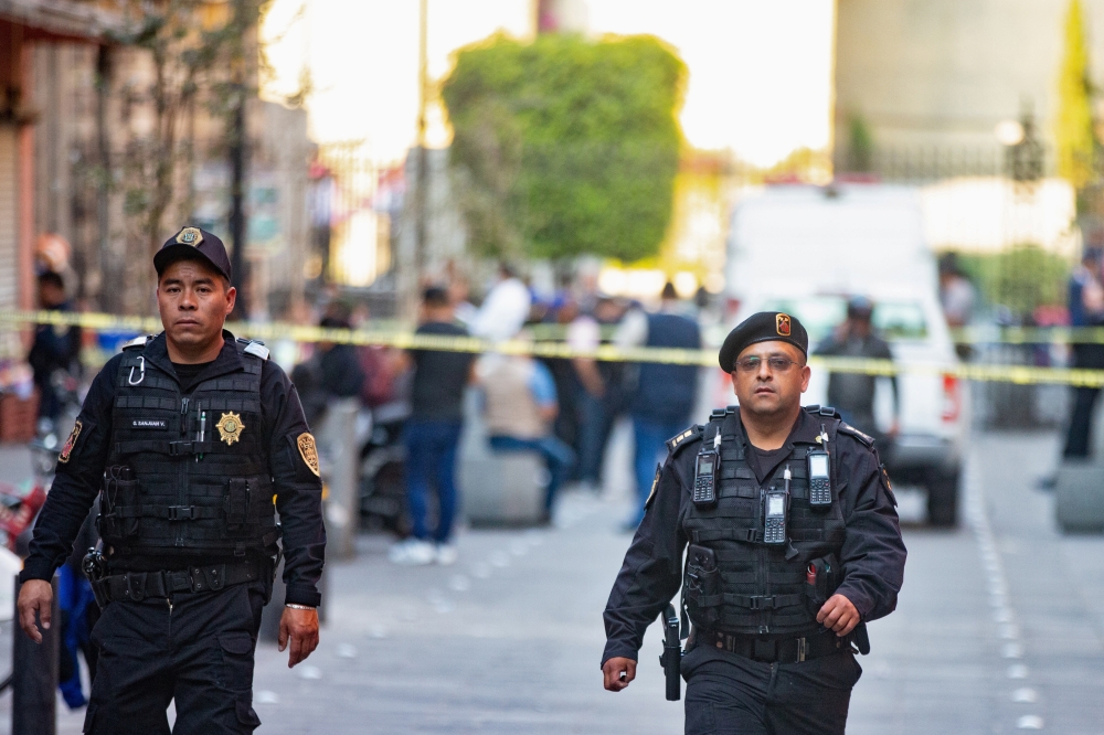 Police officers guard a crime scene where four people were killed and two injured in a shooting near Mexico's National Palace, the presidential residence in the capital's historic downtown, officials said, in Mexico City, Mexico December 7, 2019. REUTERS/