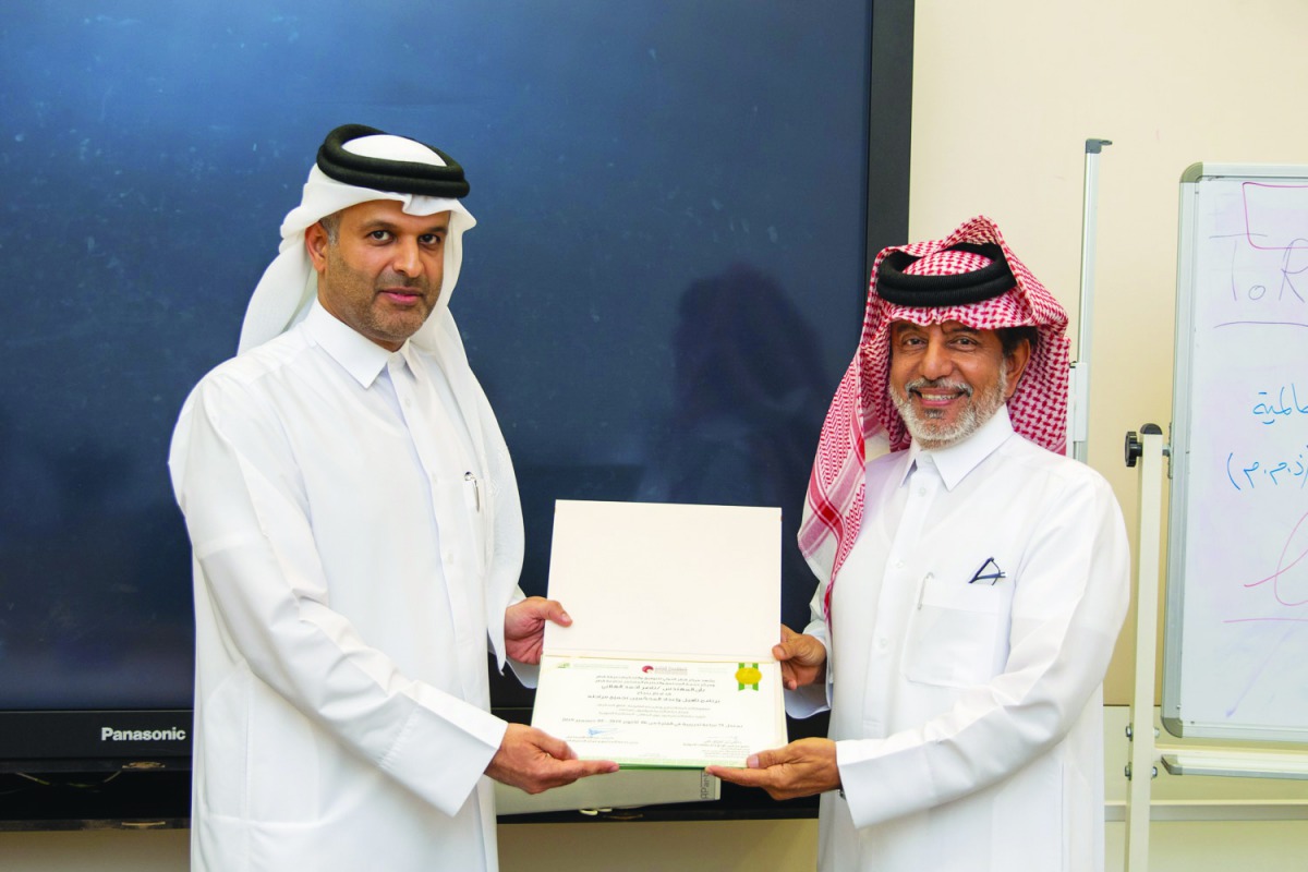QICCA board member for International Relations Sheikh Dr Thani bin Ali Al Thani presenting the certificate to one of the participants.