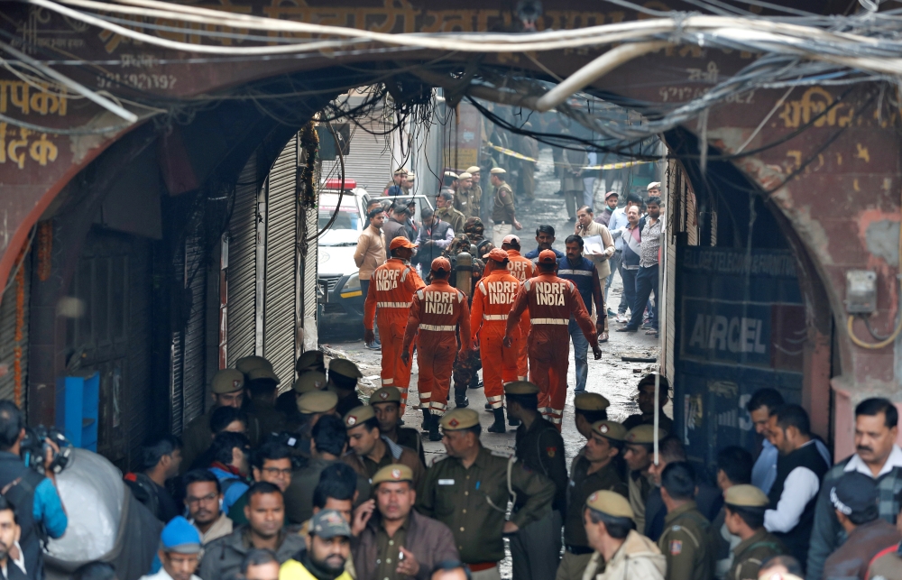 Members of India's National Disaster Response Force (NDRF) head towards the site of a fire that swept through a factory where laborers were sleeping, in New Delhi, India December 8, 2019. REUTERS/Adnan Abidi
