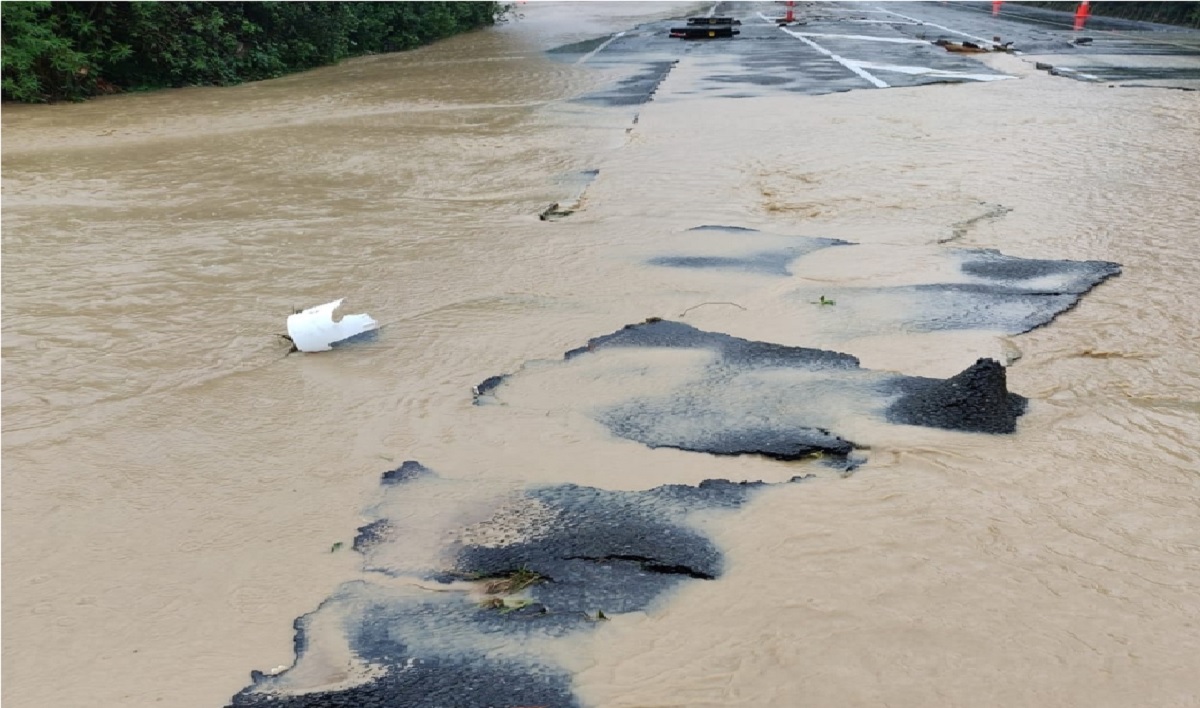 Floodwaters are seen on a cracked road on State Highway 58 in Judgeford, New Zealand December 8, 2019 in this picture obtained from social media. STEVE AND LISA KOVACS /via REUTERS