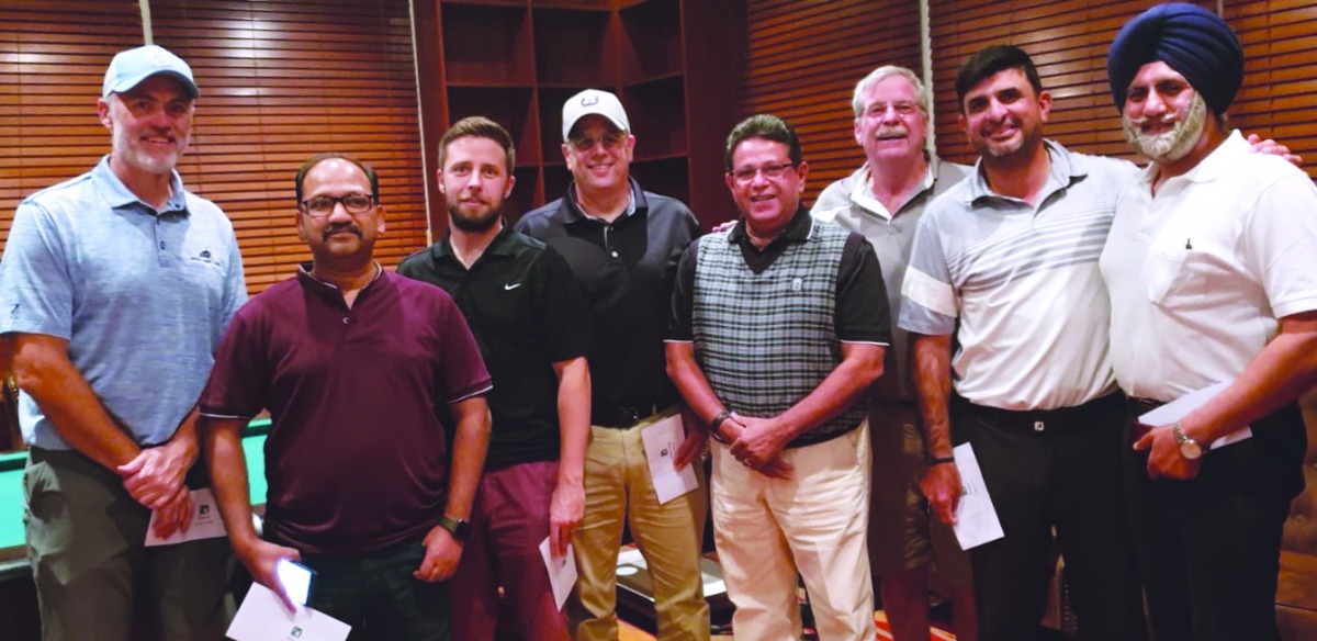 Winning golfers posing for a photograph during the prize distribution ceremony of Qatar Golf Lovers Tournament at the Doha Golf Club.