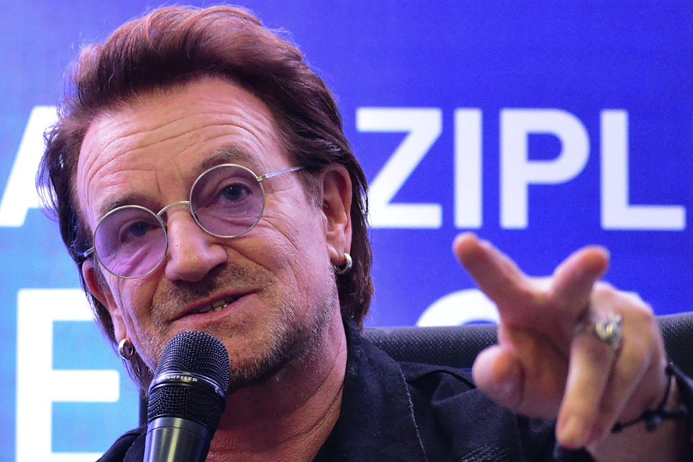 U2 frontman singer Bono speaks to the media during a signing ceremony in Manila on December 10, 2019. AFP / Maria Tan 