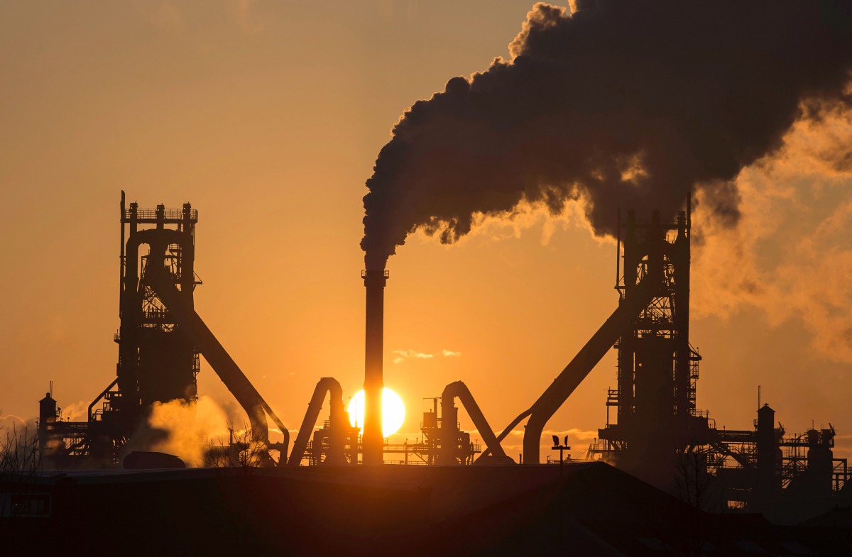The sun rising above Tata Steels blast furnaces at their Scunthorpe Plant in north east England. AFP file photo / Lindsey Parnaby