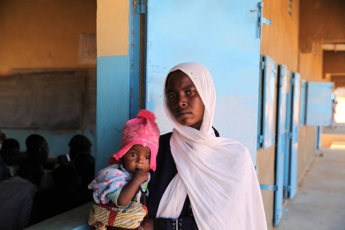 Mouna Issahk poses for a portrait with her daughter at her school in Touloum refugee camp, Iriba, Chad, November 27, 2019. Thomson Reuters Foundation/Nellie Peyton