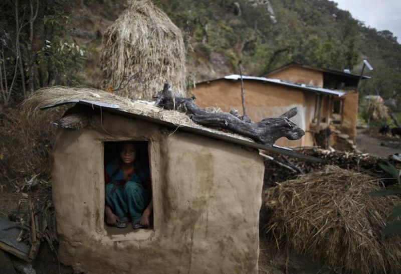 In this 2014 archive photo a 14-year old girl sits inside a Chaupadi shed in the hills of Legudsen village in Achham District in western Nepal. Reuters / Navesh Chitrakar