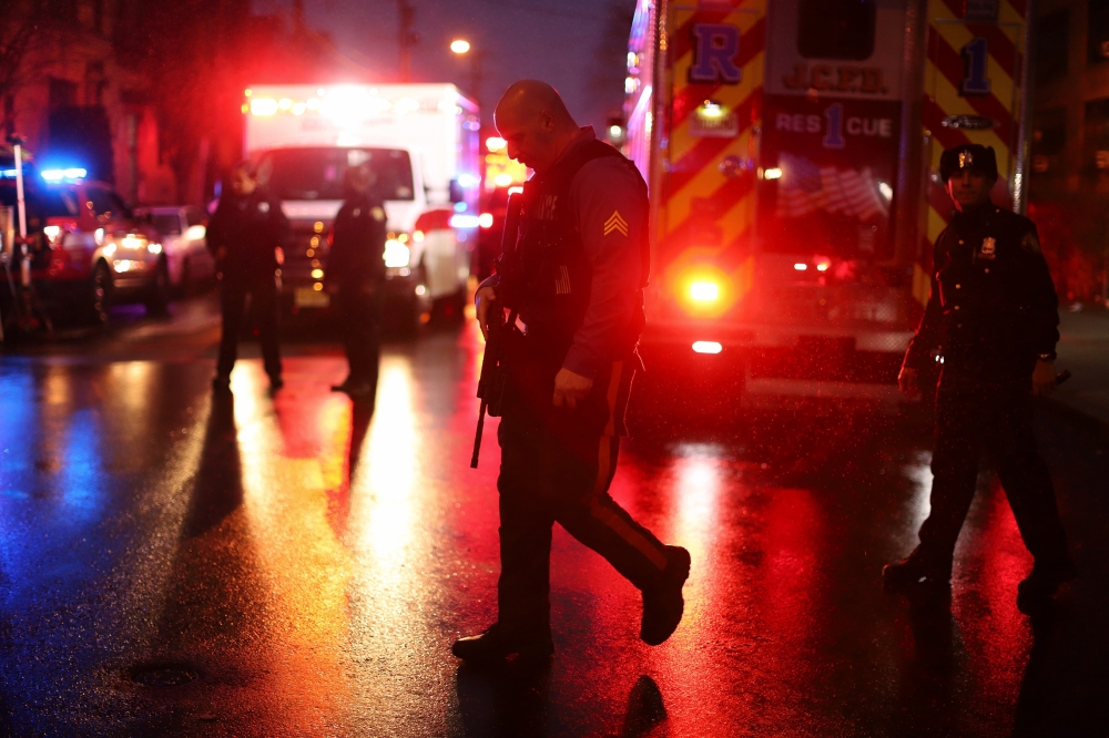 JERSEY CITY, NJ - DECEMBER 10: Emergency personnel are shown on the scene of a shooting that left multiple people dead on December 10, 2019 in Jersey City, New Jersey. In a raging gun battle that by some accounts lasted in excess of an hour, six people - 