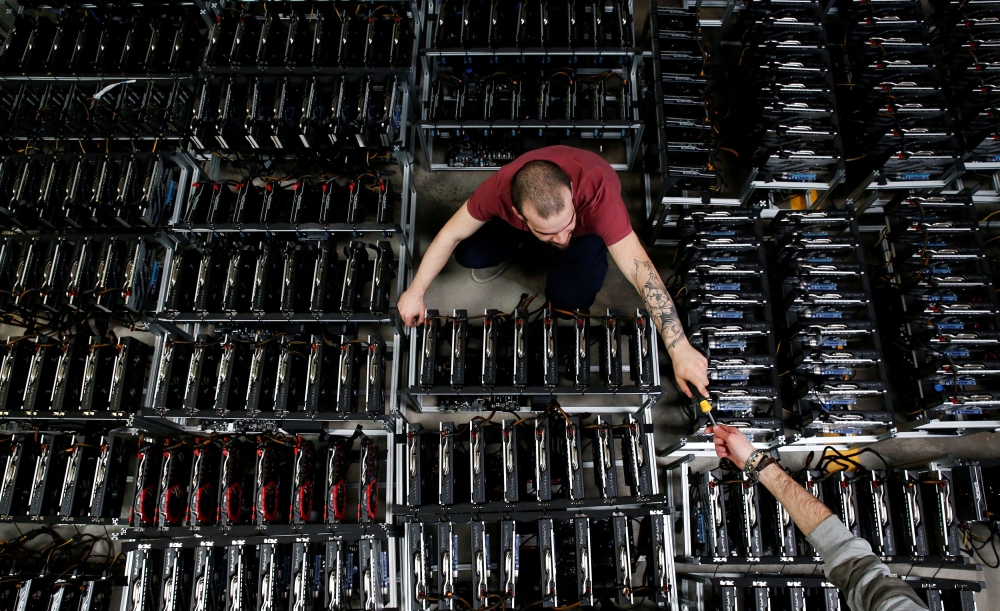 Employees work on bitcoin mining computers at Bitminer Factory in Florence, Italy, April 6, 2018. Picture taken April 6, 2018. Reuters/Alessandro Bianchi