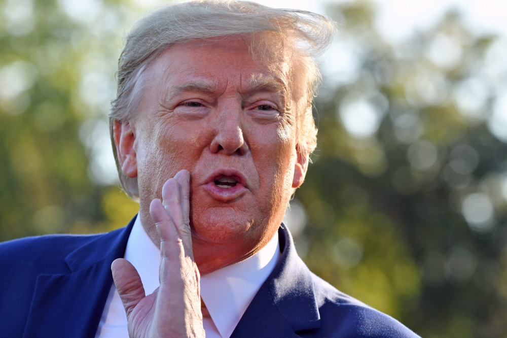 Donald Trump speaks to the press after announcing and initial deal with China at the South Lawn of the White House on October 11, 2019. AFP / Nicholas Kamm