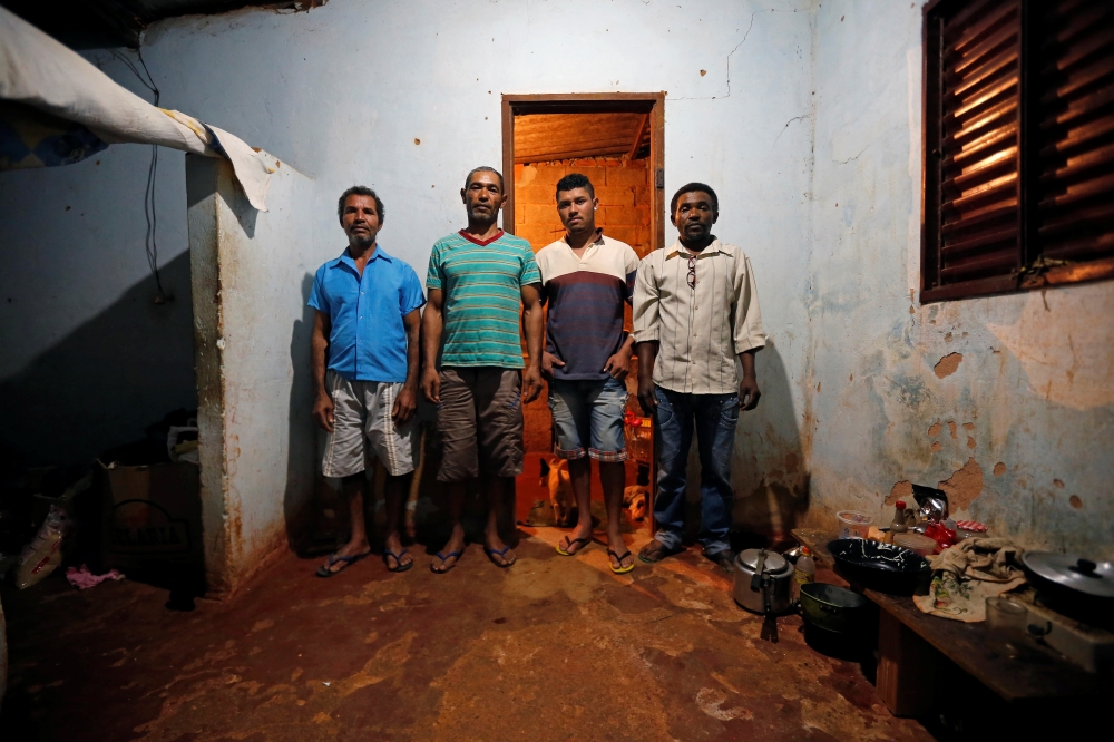 Paulo Santos de Jesus, Sales Felix, Joseilton de Jesus and Genivaldo Batista dos Santos pose for a picture after working on a coffee farm, during a labor ministry operation to identify workers in conditions analogous to slavery, in Campos Altos, Minas Ger