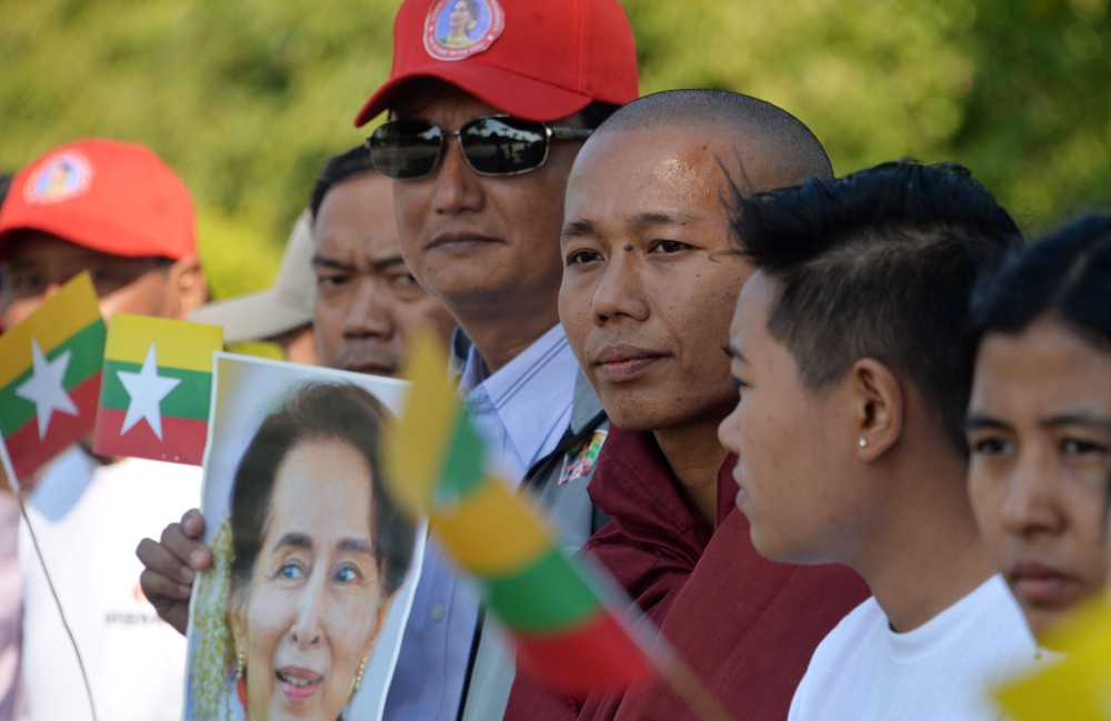 The Supporters of Myanmar's State Counselor Aung San Suu Kyi line up the street for her arrival from Naypyidaw International Airport to Naypyidaw on December 14, 2019. AFP / Thet Aung 