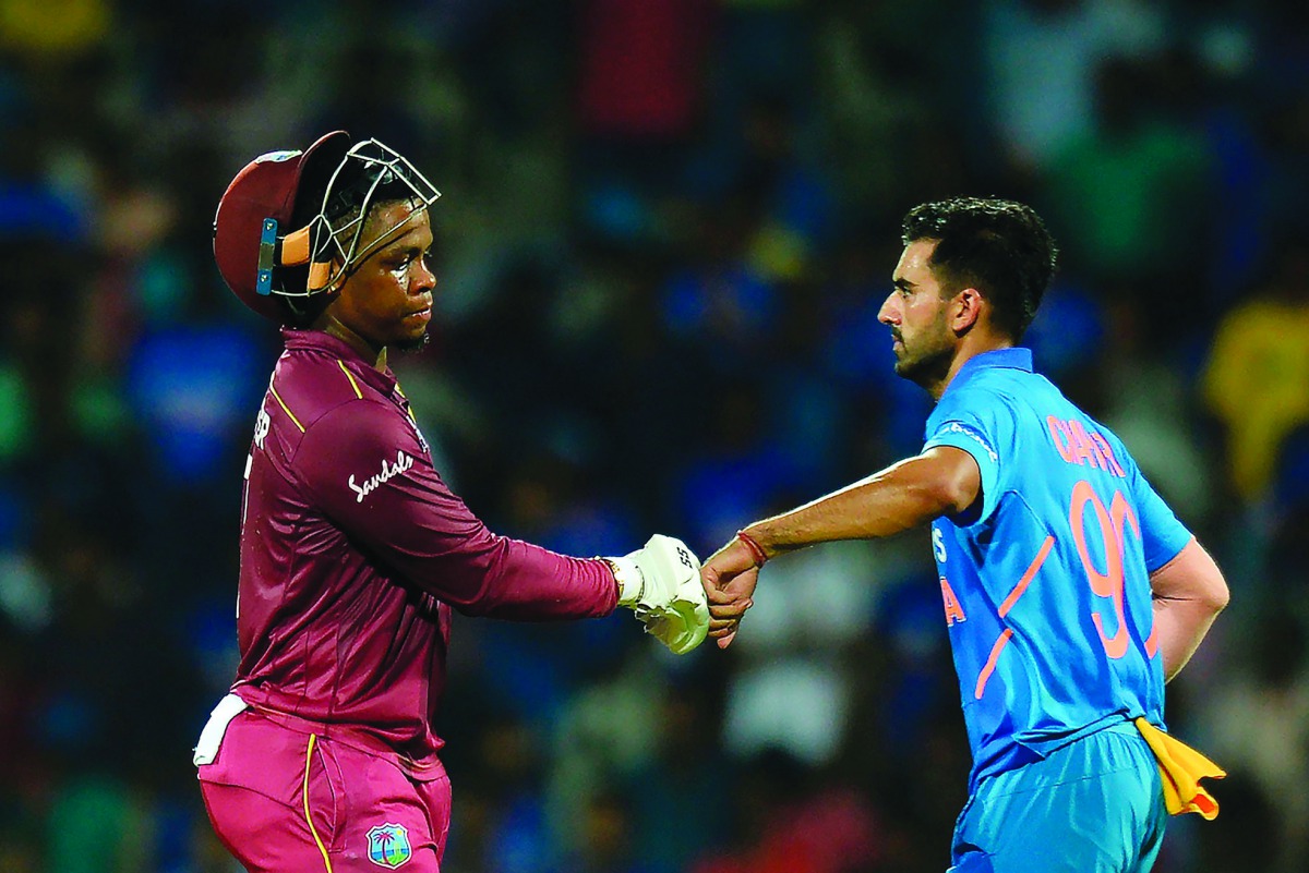 West Indies' Shimron Hetmyer (L) gestures along with India's Deepak Chahar as he walks back to the pavilion after he got caught during the first one day international cricket match of a three-match series between India and West Indies, at the M.A. Chidamb