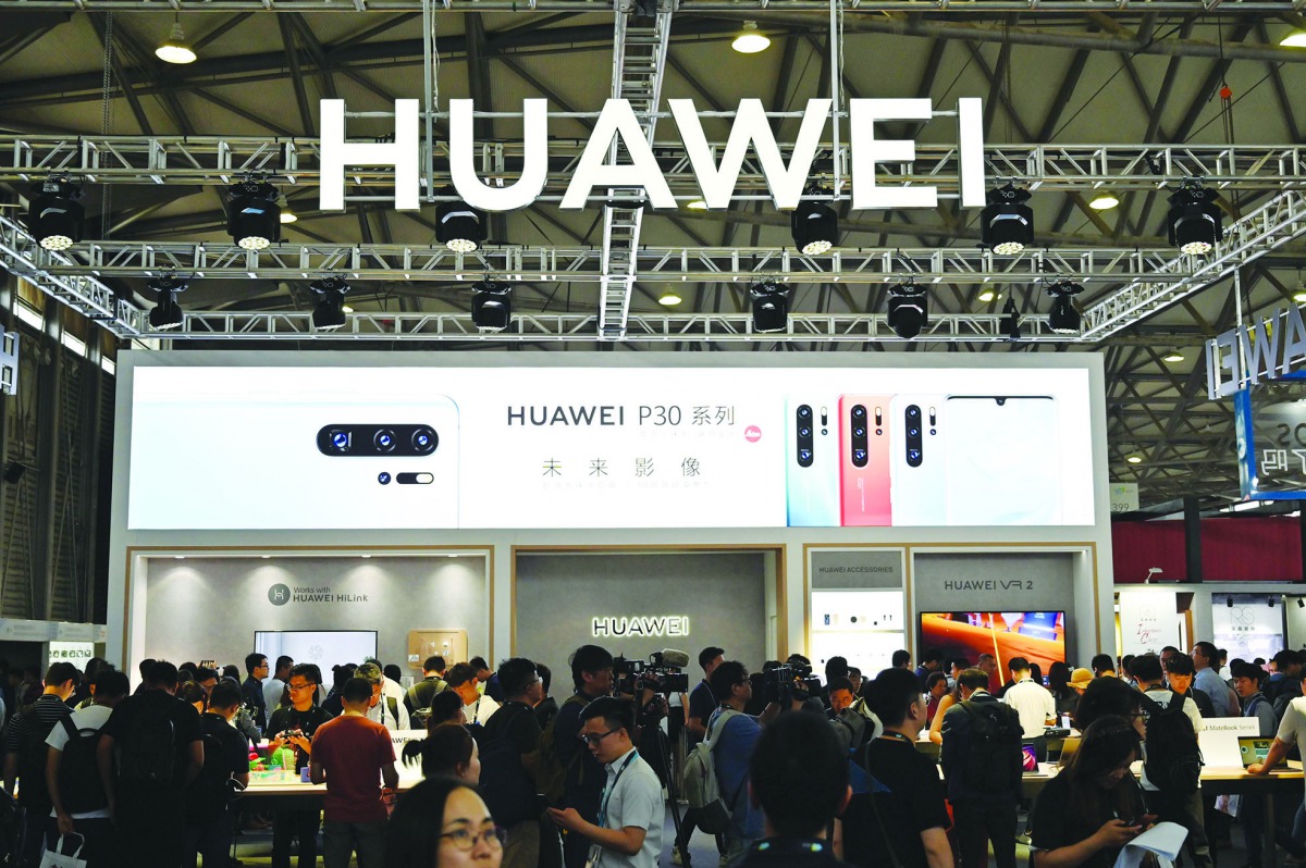 This file photo taken on June 11, 2019 shows people gathering at a Huawei stand during the Consumer Electronics Show, Ces Asia 2019 in Shanghai. AFP