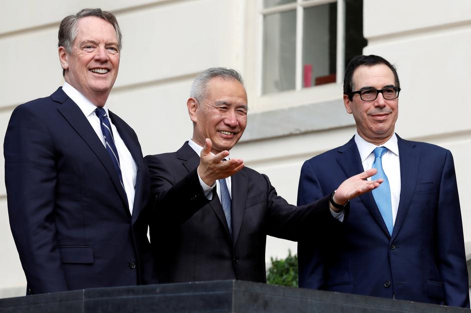 FILE PHOTO: China's Vice Premier Liu He gestures to the media between U.S. Trade Representative Robert Lighthizer (L) and Treasury Secretary Steve Mnuchin before the two countries' trade negotiations in Washington, U.S., October 10, 2019. REUTERS/Yuri Gri