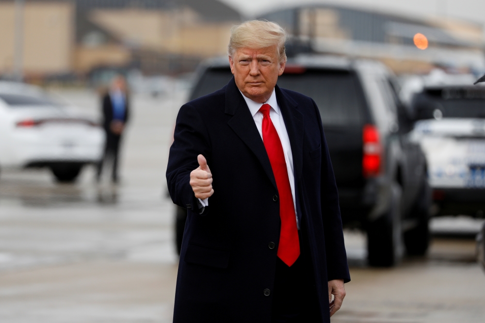 FILE PHOTO: U.S. President Donald Trump gestures as he arrives to board Air Force One at Joint Base Andrews, Maryland, U.S., December 14, 2019. REUTERS/Tom Brenner/File Photo