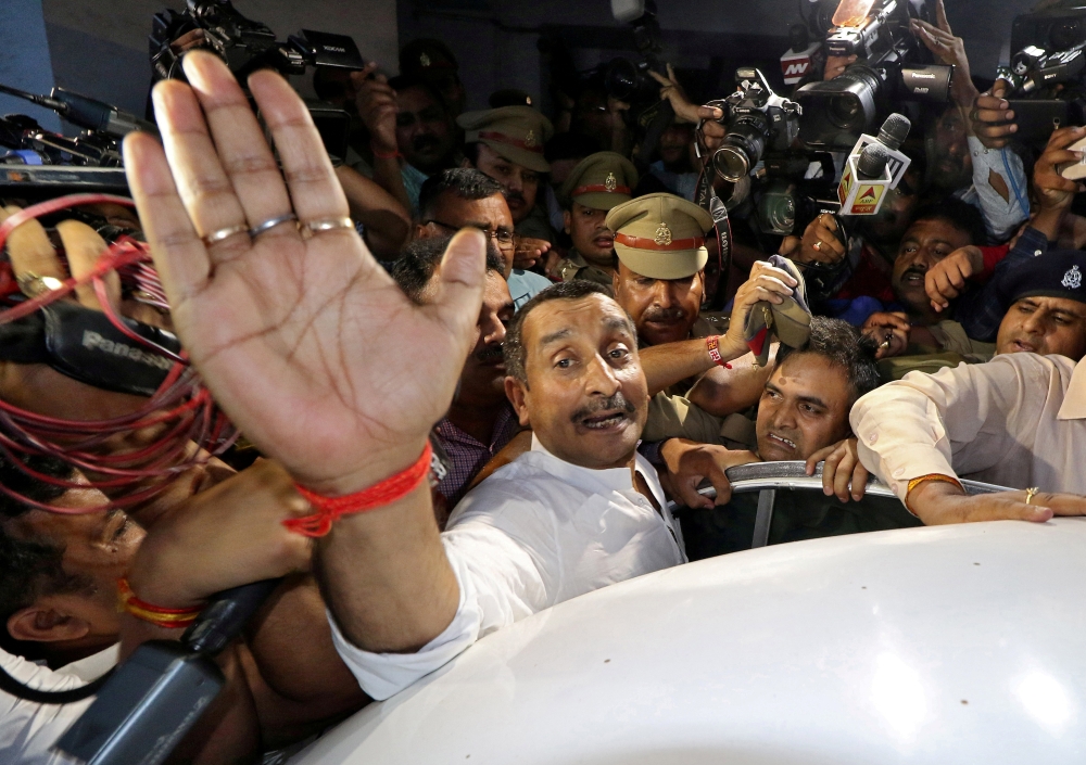 Kuldeep Singh Sengar, a legislator of Uttar Pradesh state from India's ruling Bharatiya Janata Party (BJP), reacts as he leaves a court after he was arrested in connection with the rape of a teenager, in Lucknow, India, April 14, 2018. Reuters/Pawan Kumar