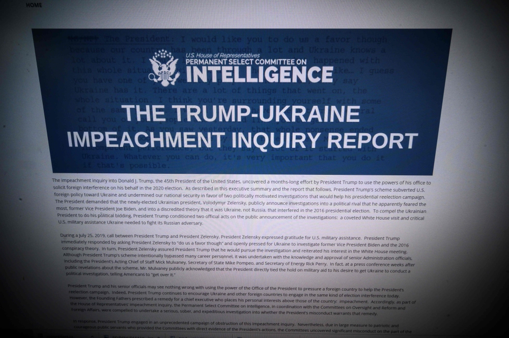 Computer screen shows a copy of the Permanent Select Committee on Intelligence Report of The Trump-Ukraine Impeachment Inquiry Report on December 3, 2019 in Washington. AFP / Eric Baradat