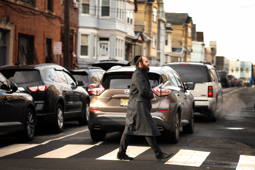 A member of the Jewish community crosses the street near the JC Kosher Supermarket on December 11, 2019 in Jersey City, New Jersey. Rick Loomis/Getty Images/AFP
