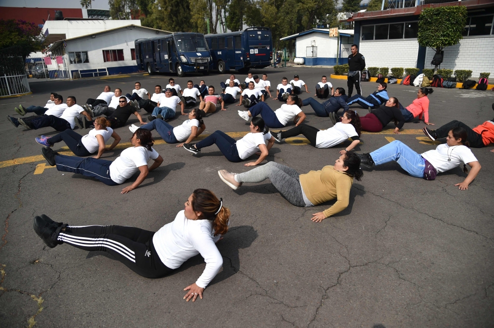 Mexican police officers excercise at a police unit in Mexico City on December 11, 2019. AFP / Rodrigo Arangua
 