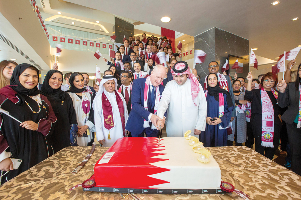 Senior officials of Katara Hospitality cutting cake during an event to celebrate Qatar National Day.