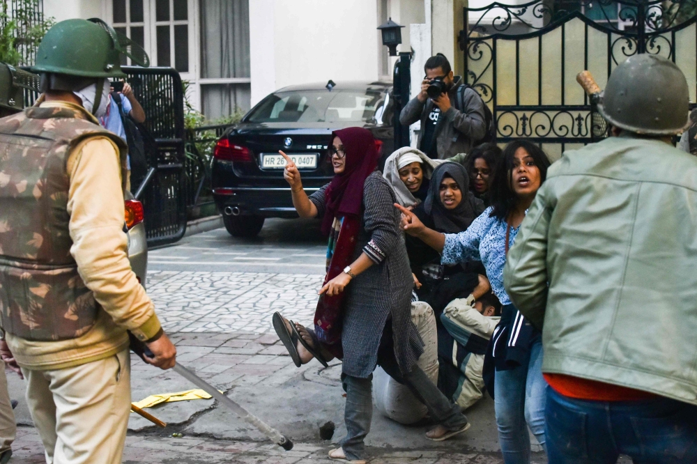 In this picture taken on December 15, 2019 Ayesha Renna  (C) and other protesters argue with policemen during a demonstration against the Indian government's Citizenship Amendment Bill (CAB) in New Delhi.  AFP 