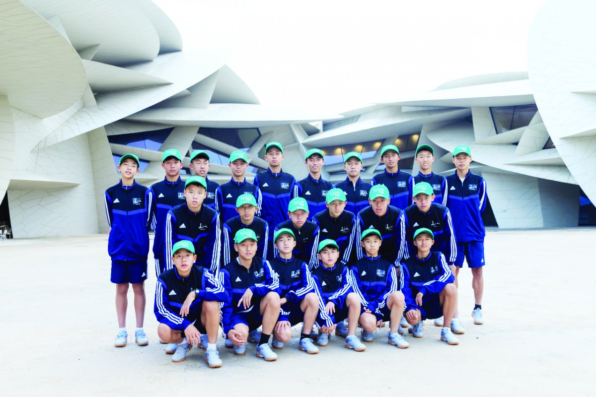 Dalian Professional FC’s Under 14 side training in Doha as part of a week long football tour of Qatar pose for a group picture.
