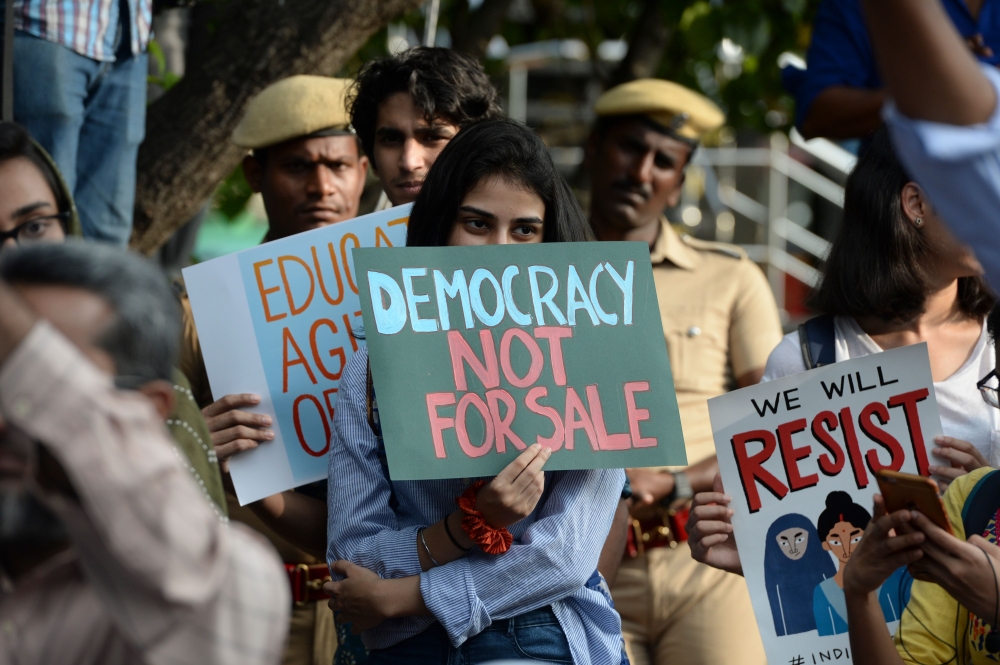 In this file photo taken on December 19, 2019 students and demonstrators hold placards during a protest against India's new citizenship law in Chennai. . / AFP / Arun SANKAR /