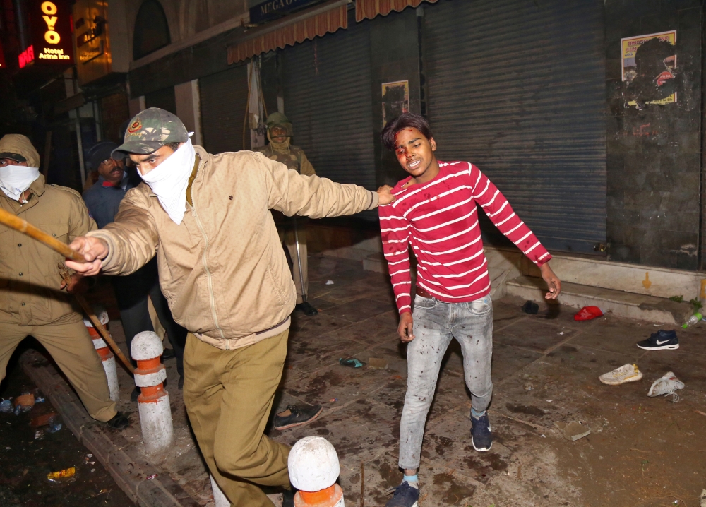 Police officers detain a man during a protest against a new citizenship law, in New Delhi, India, December 20, 2019. Reuters