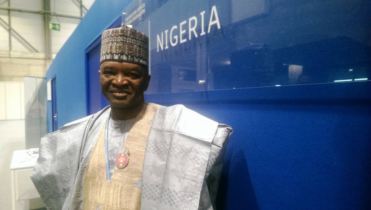 Nigerian Environment Minister Mohammad Mahmood Abubakar poses for a picture in front of his country's office at the U.N. climate conference in Madrid, December 11, 2019. Thomson Reuters Foundation/Megan Rowling