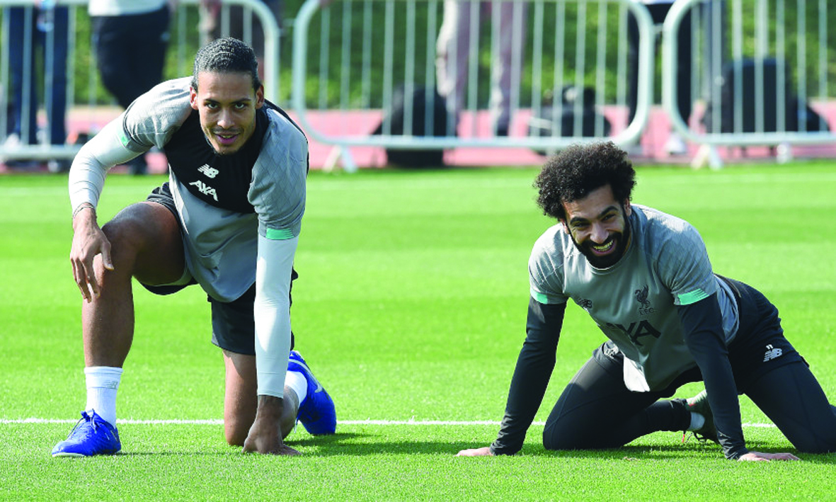 Liverpool’s Virgil van Dijk (left) and Mohamed Salah during a practice session in Doha, yesterday..