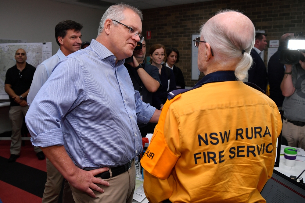 Australia's Prime Minister Scott Morrison greets a volunteer during a visit to the Wollondilly Emergency Control Centre in Sydney, Australia, December 22, 2019. AAP Image/Joel Carrett/via Reuters