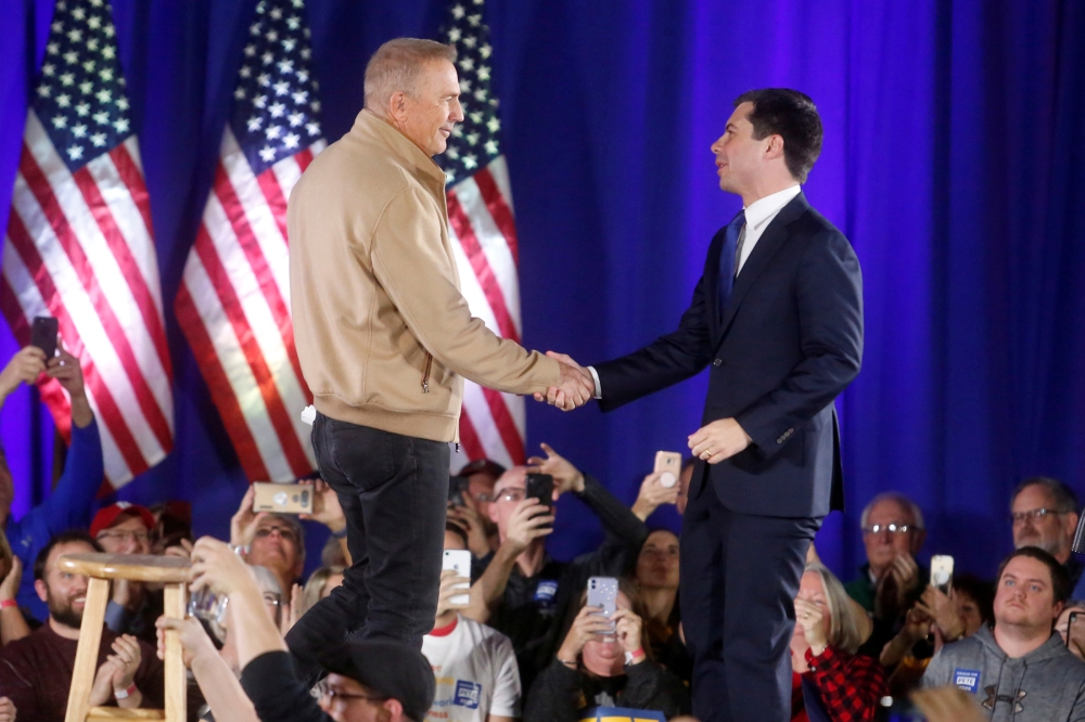 Democratic presidential candidate Pete Buttigieg shakes hands with actor Kevin Costner as he receives his endorsement during a campaign event at a high school in Indianola, Iowa, U.S. December 22, 2019. (REUTERS/Rachel Mummey)