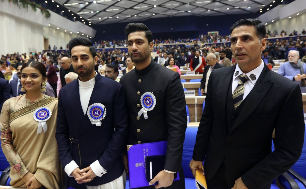 Bollywood actors and award winners Keerthy Suresh (L), Ayushmann Khurrana (2nd L), Vicky Kaushal (2nd R) and Akshay Kumar pose for a photo at the National Film Awards ceremony in New Delhi on December 23, 2019. (AFP)