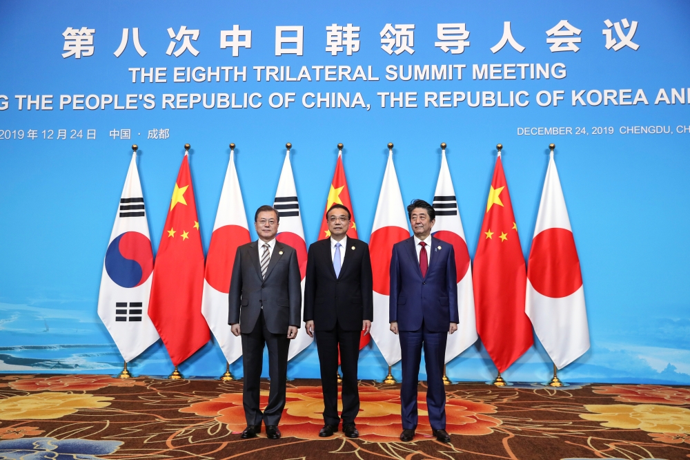 China's Premier Li Keqiang, Japan's Prime Minister Shinzo Abe and South Korea's President Moon Jae-in pose for pictures ahead of the 8th trilateral leaders' meeting in Chengdu, Sichuan province, China December 24, 2019. China Daily via Reuters