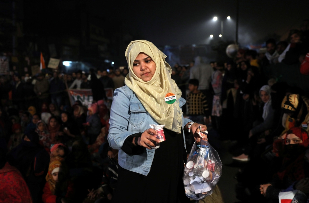 A demonstrator collects garbage during a protest against a new citizenship law, in New Delhi, India, December 21, 2019. Picture taken December 21, 2019. Reuters/Anushree Fadnavis
 