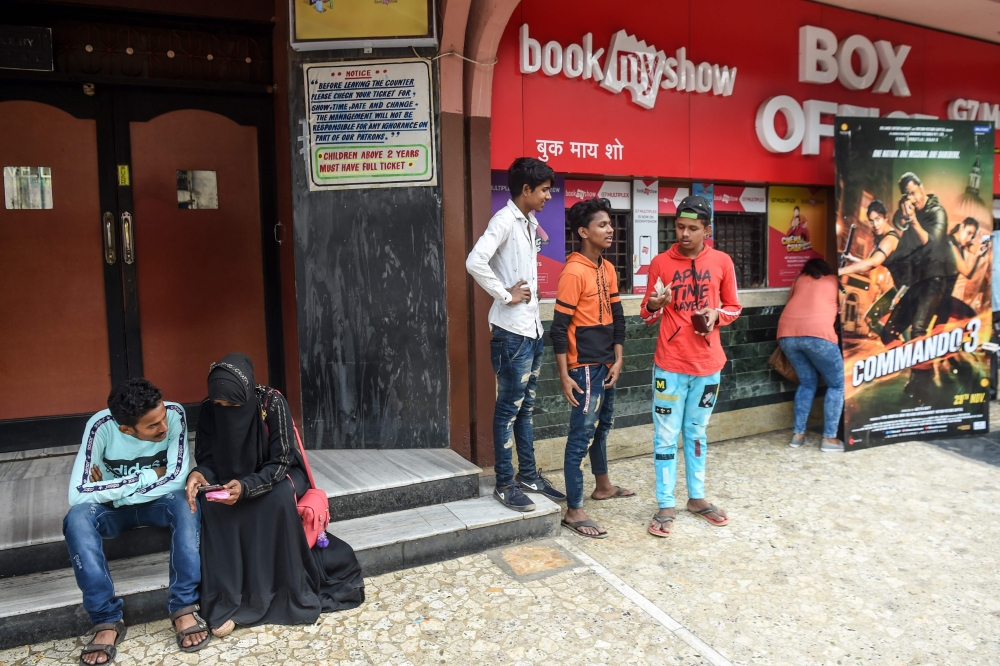 In this photograph taken on December 1, 2019, people wait to enter a cinema in Mumbai.  AFP / Indranil Mukherjee